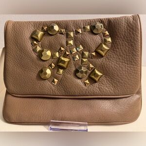 Felix Rey pebbled leather tan clutch with studded bow on front flap.